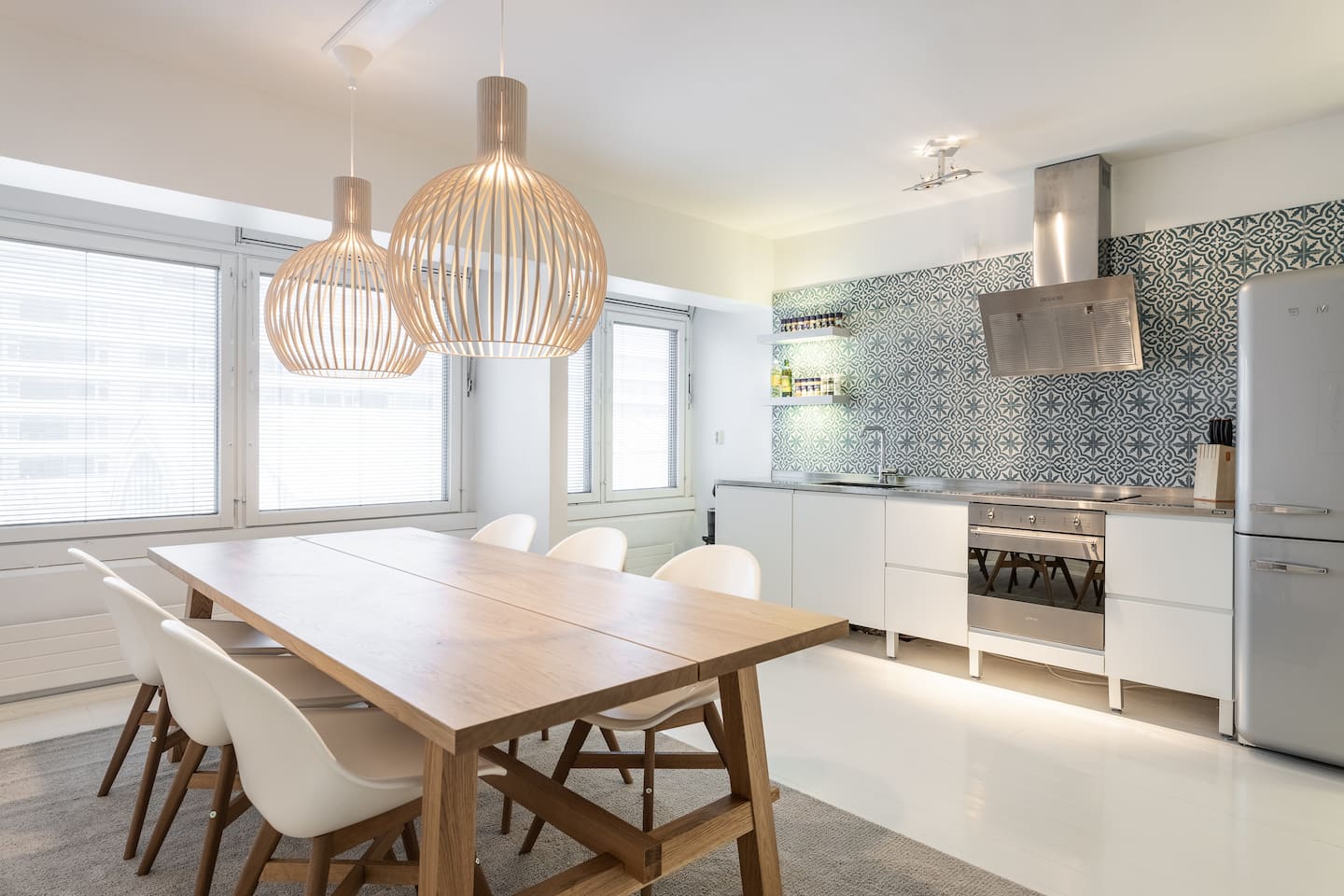 Bright kitchen and dining room with designer lighting — Large Apartment in City Centre