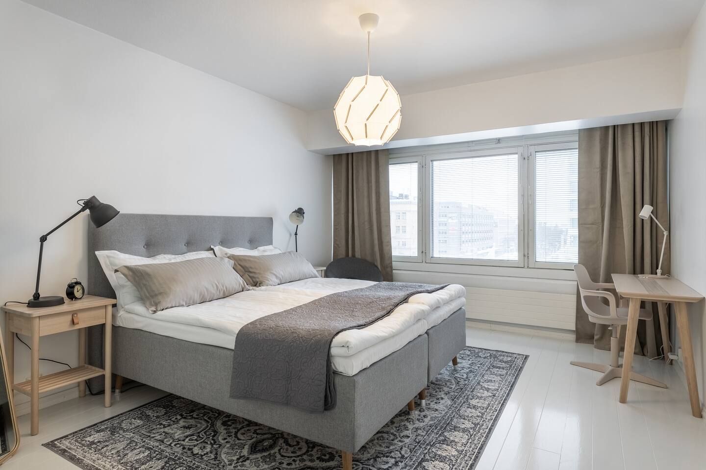 Master bedroom with double bed and workspace