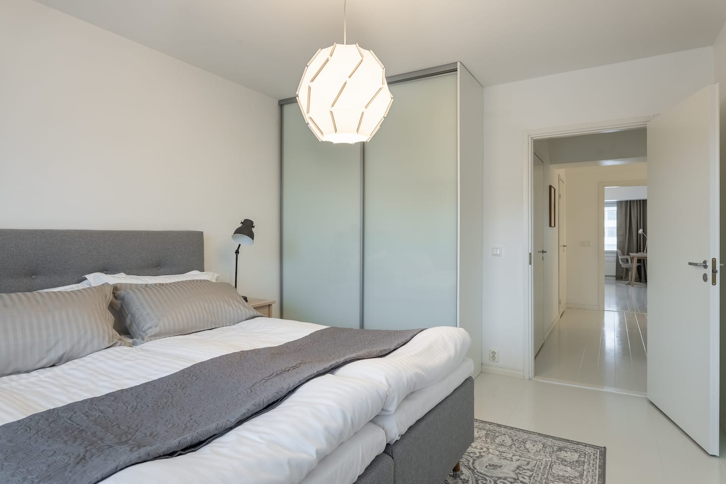 Second bedroom with white wood floors