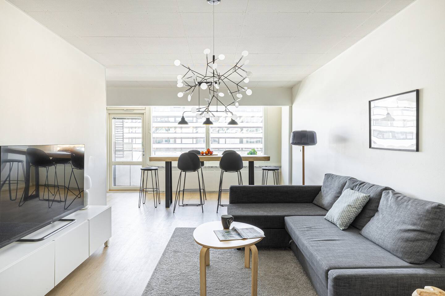 Living room with sectional sofa and dining area — Modern 4-Room Apartment